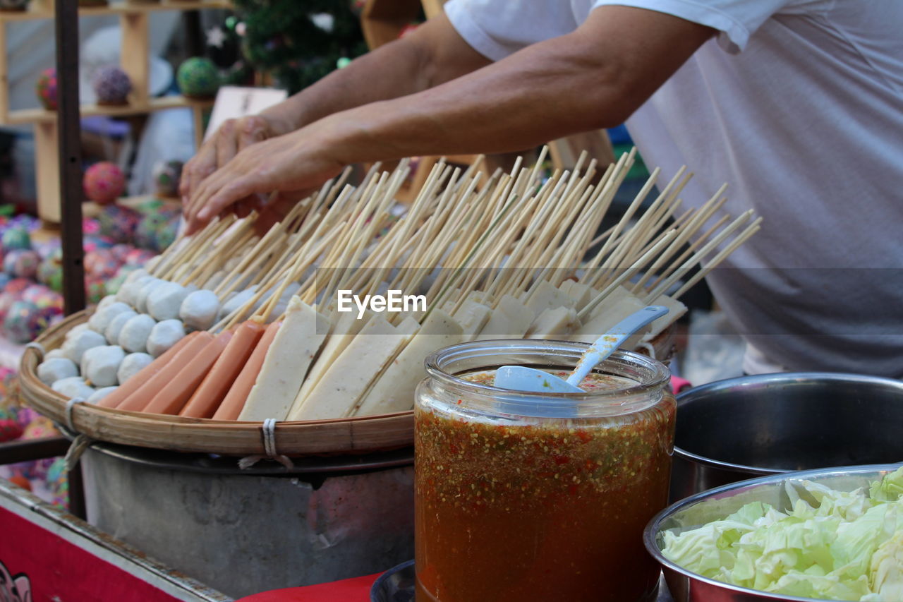 Midsection of man preparing food