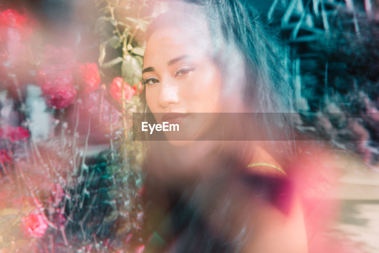 Portrait of multiracial female through cracked glass prism