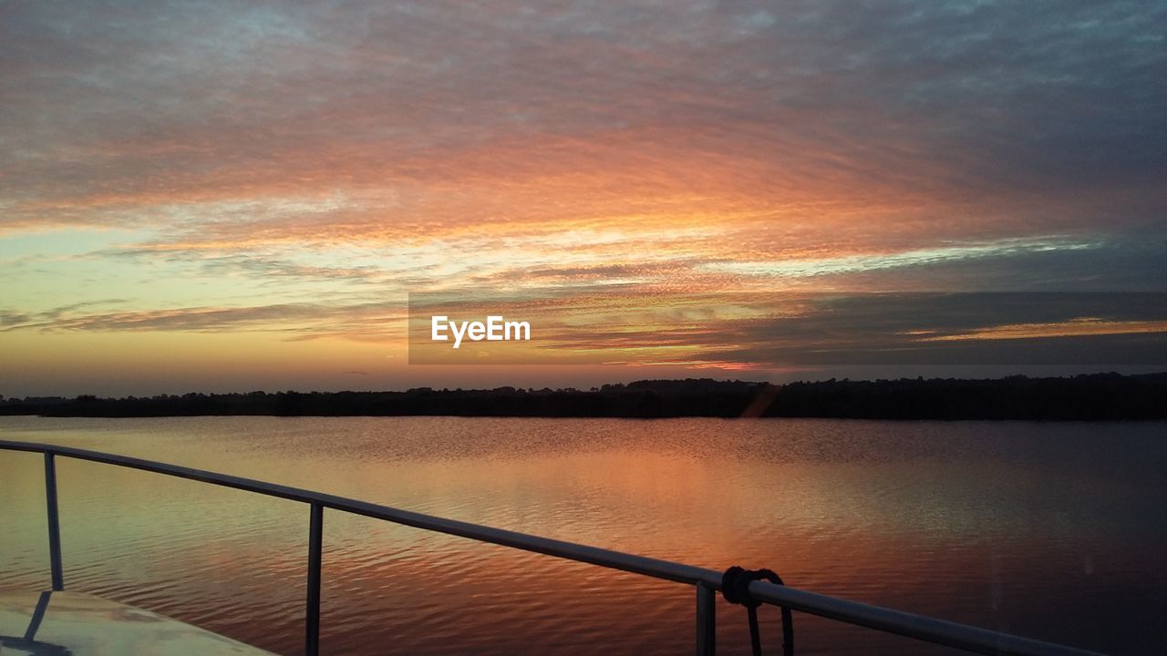 SUNSET OVER CALM LAKE