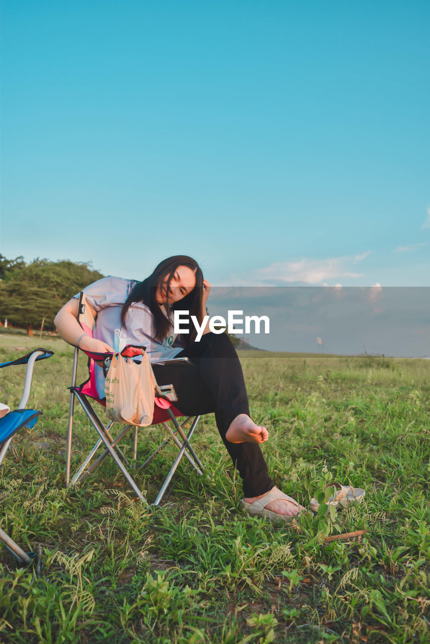 Young woman sitting on field