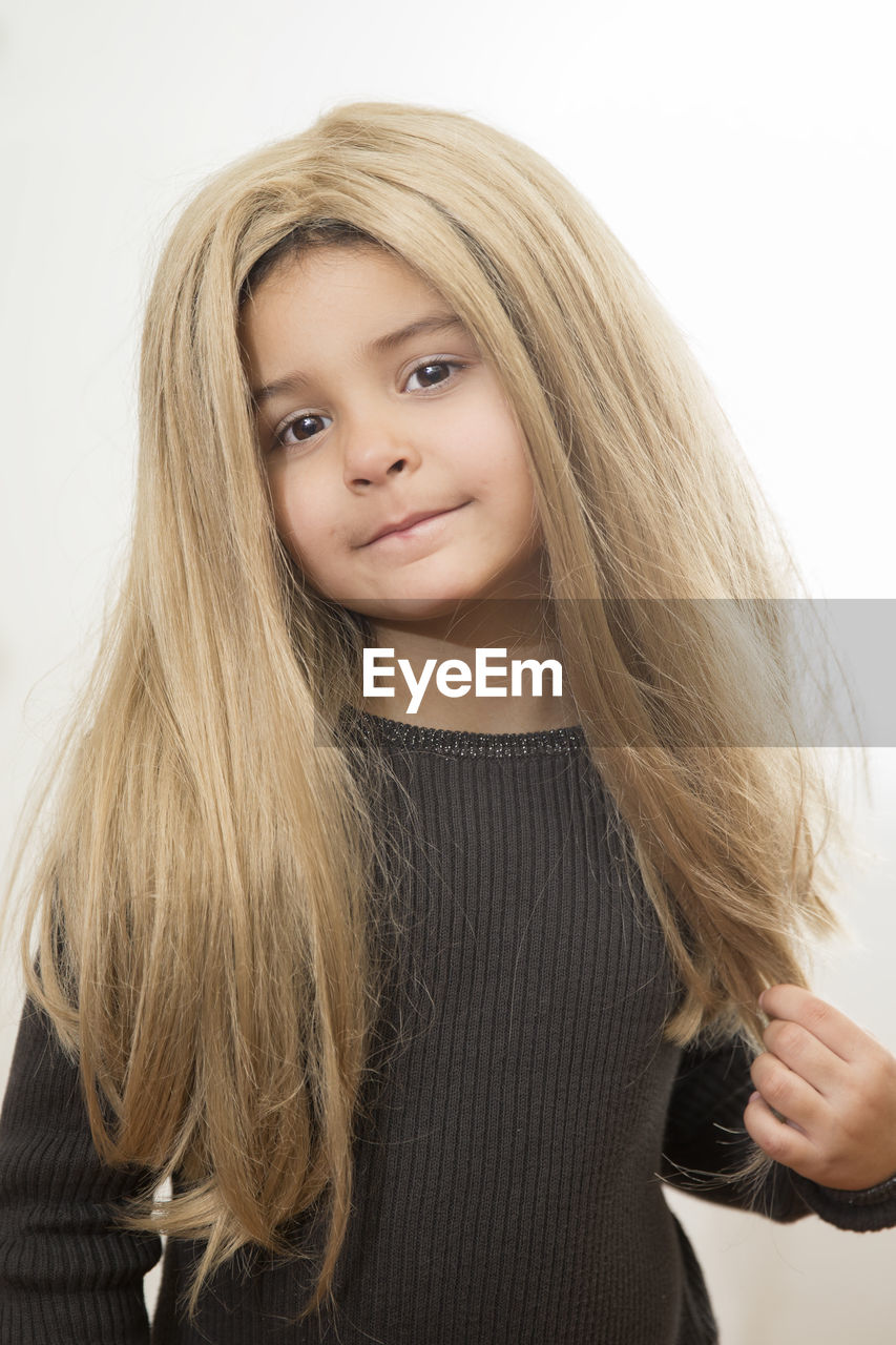 Portrait of girl with long hair against white background