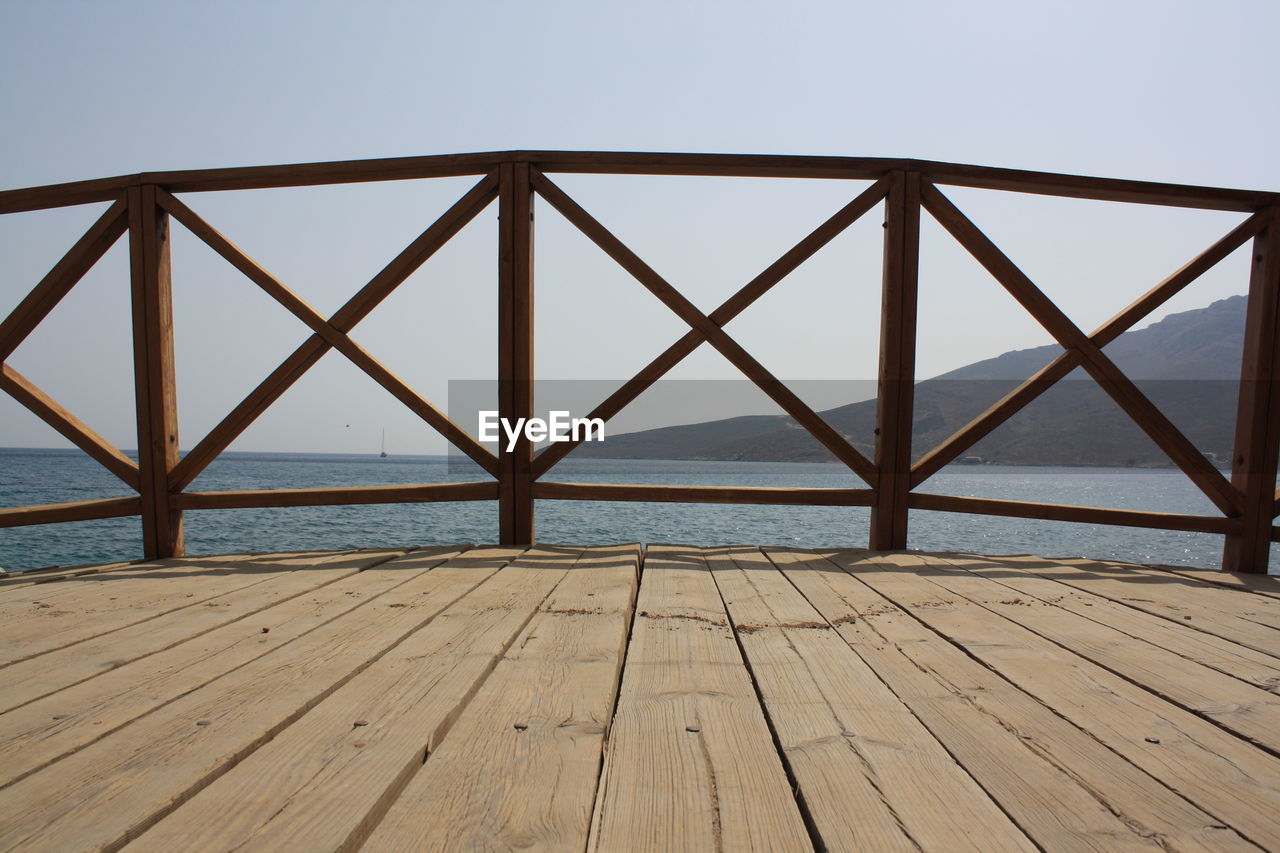 Bridge over sea against clear sky