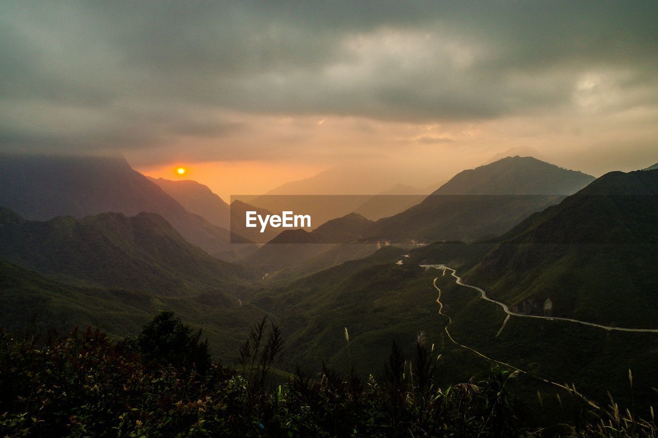 High angle view of grassy mountains during sunset