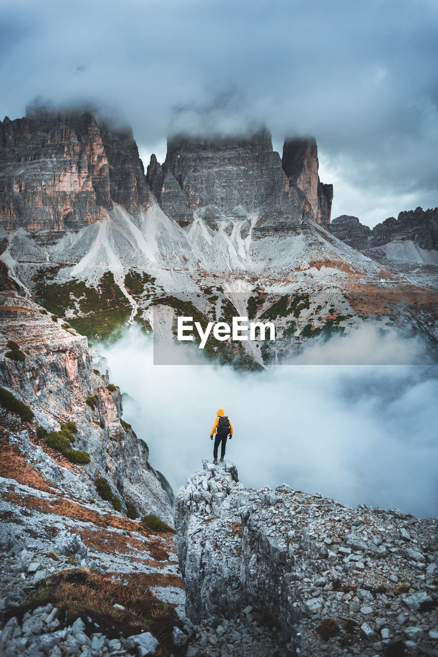 Rear view of man standing on mountain