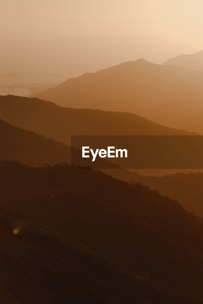 SILHOUETTE MOUNTAINS AGAINST SKY DURING SUNSET