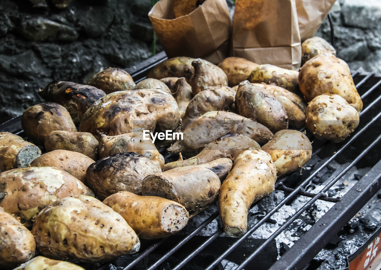 High angle view of grilled sweet potatoes on barbecue grill
