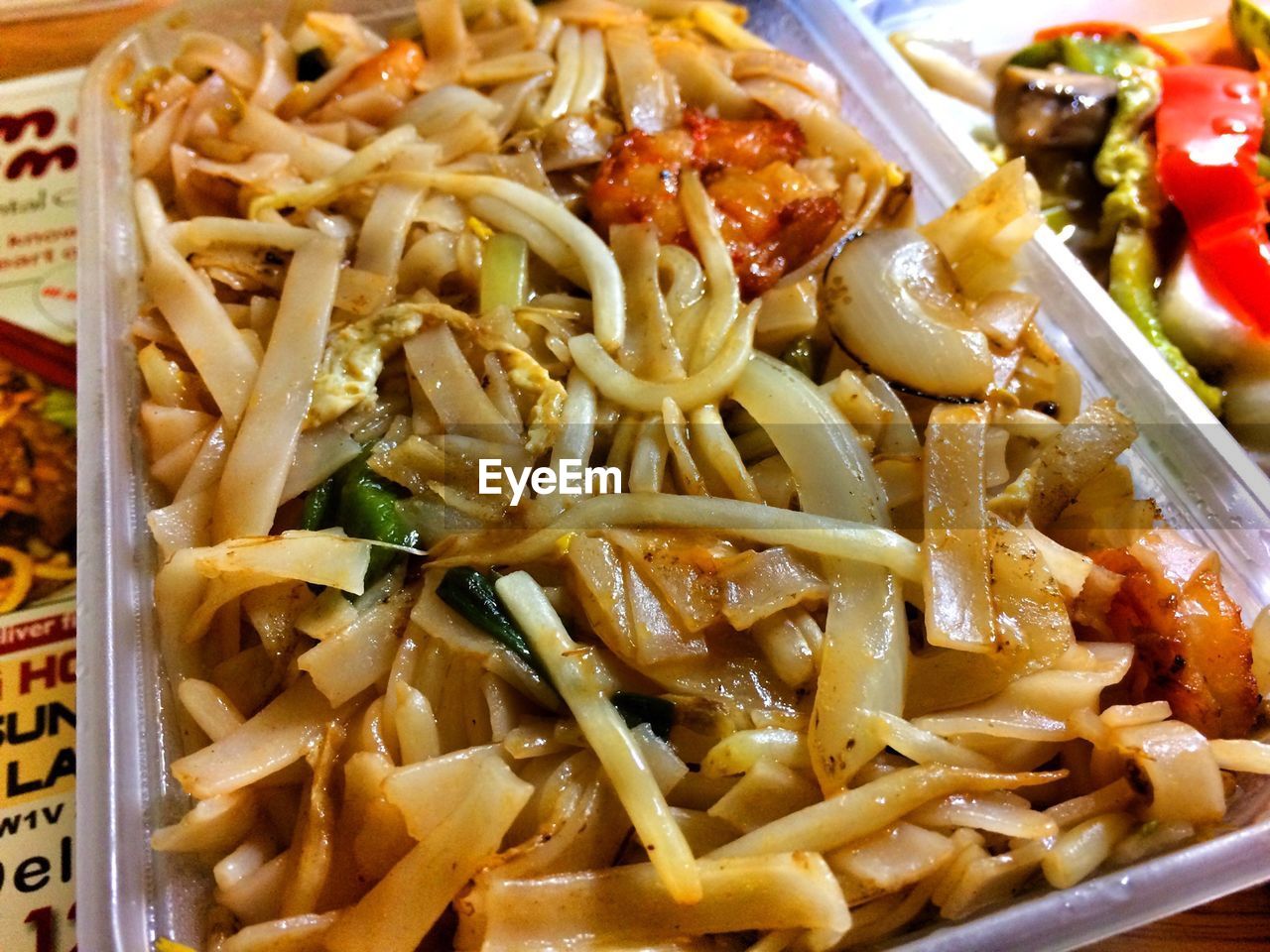 High angle view of pad thai in container on table