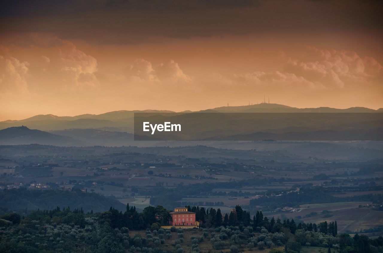 SCENIC VIEW OF MOUNTAINS AGAINST DRAMATIC SKY