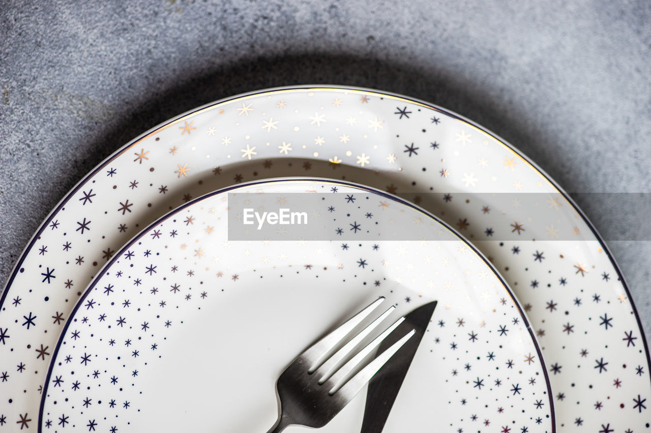 Minimalistic table setting for christmas dinner on white concrete table