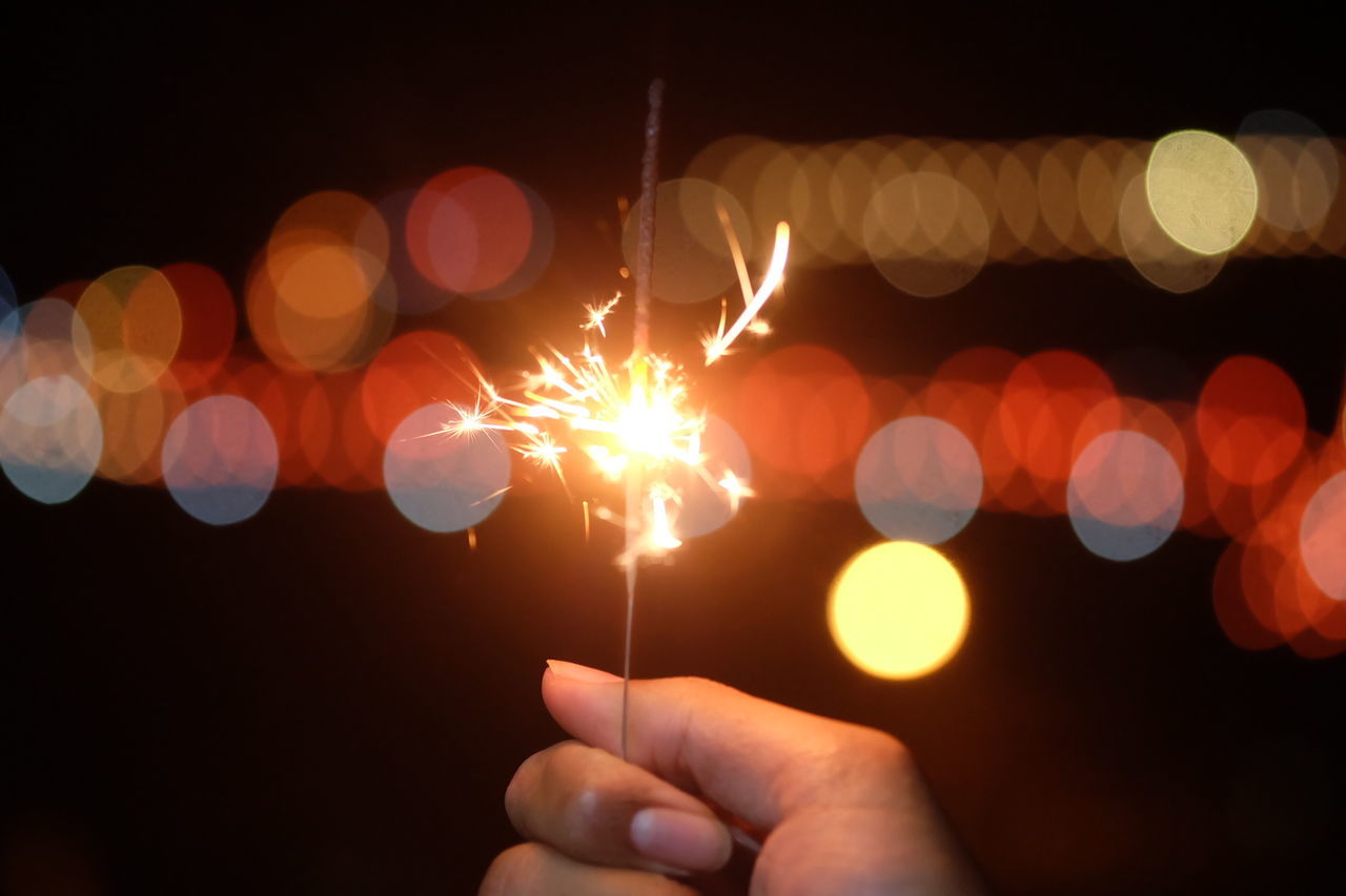 Cropped image of hand holding sparkler