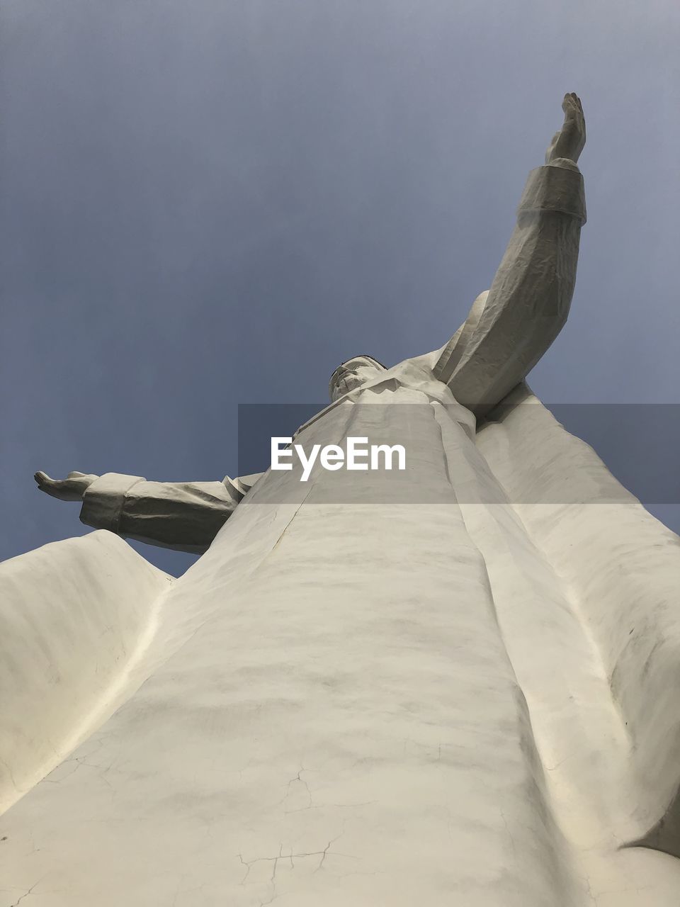 LOW ANGLE VIEW OF A STATUE OF A BUDDHA