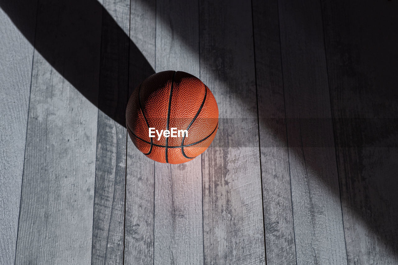 High angle view of basketball on hardwood floor