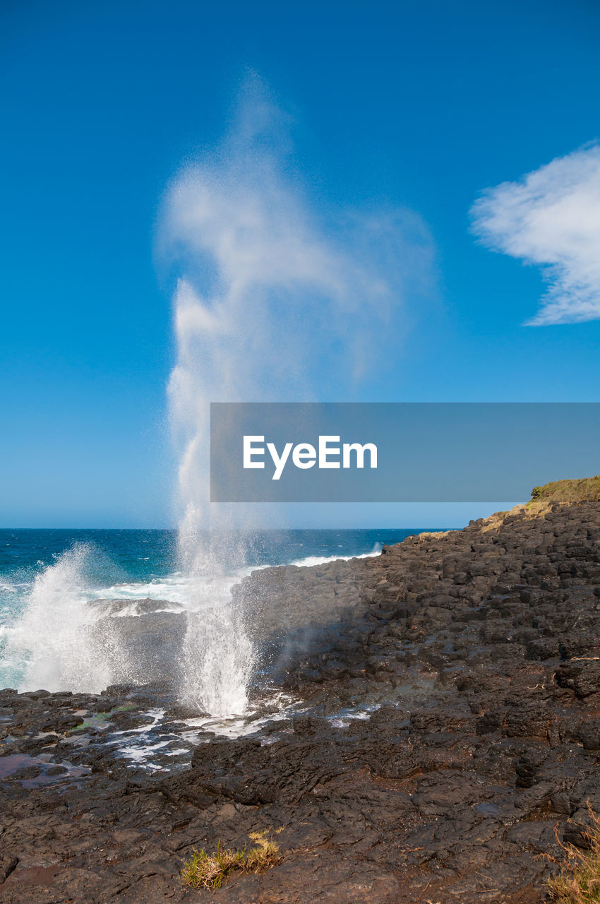 Waterhole with stream of water up in the air. nature background. kiama, australia