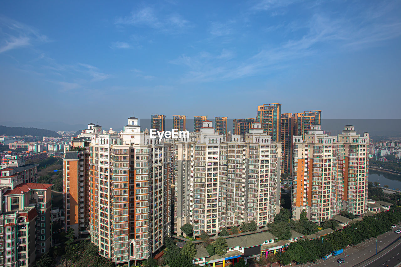 HIGH ANGLE VIEW OF MODERN BUILDINGS AGAINST SKY