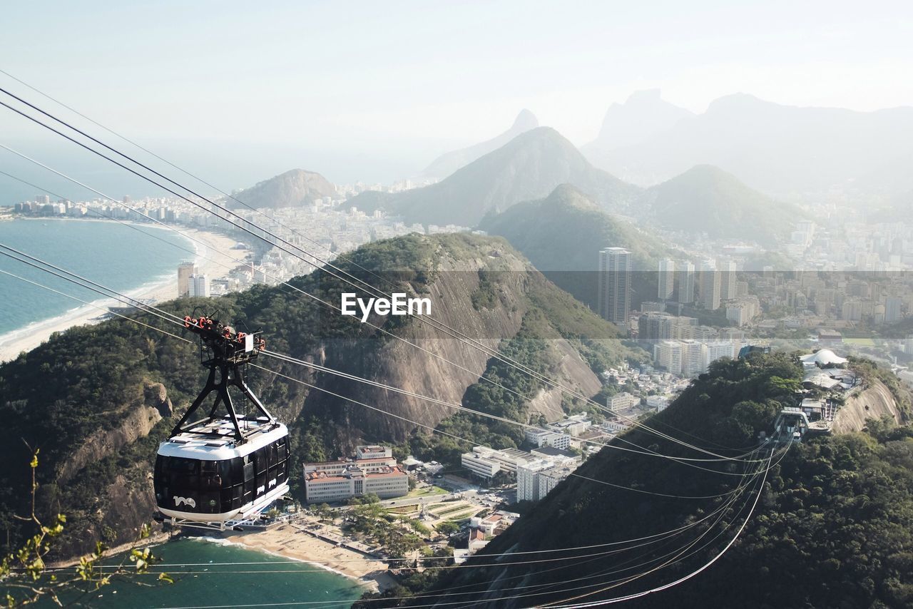 High angle view of cable car over mountains against clear sky