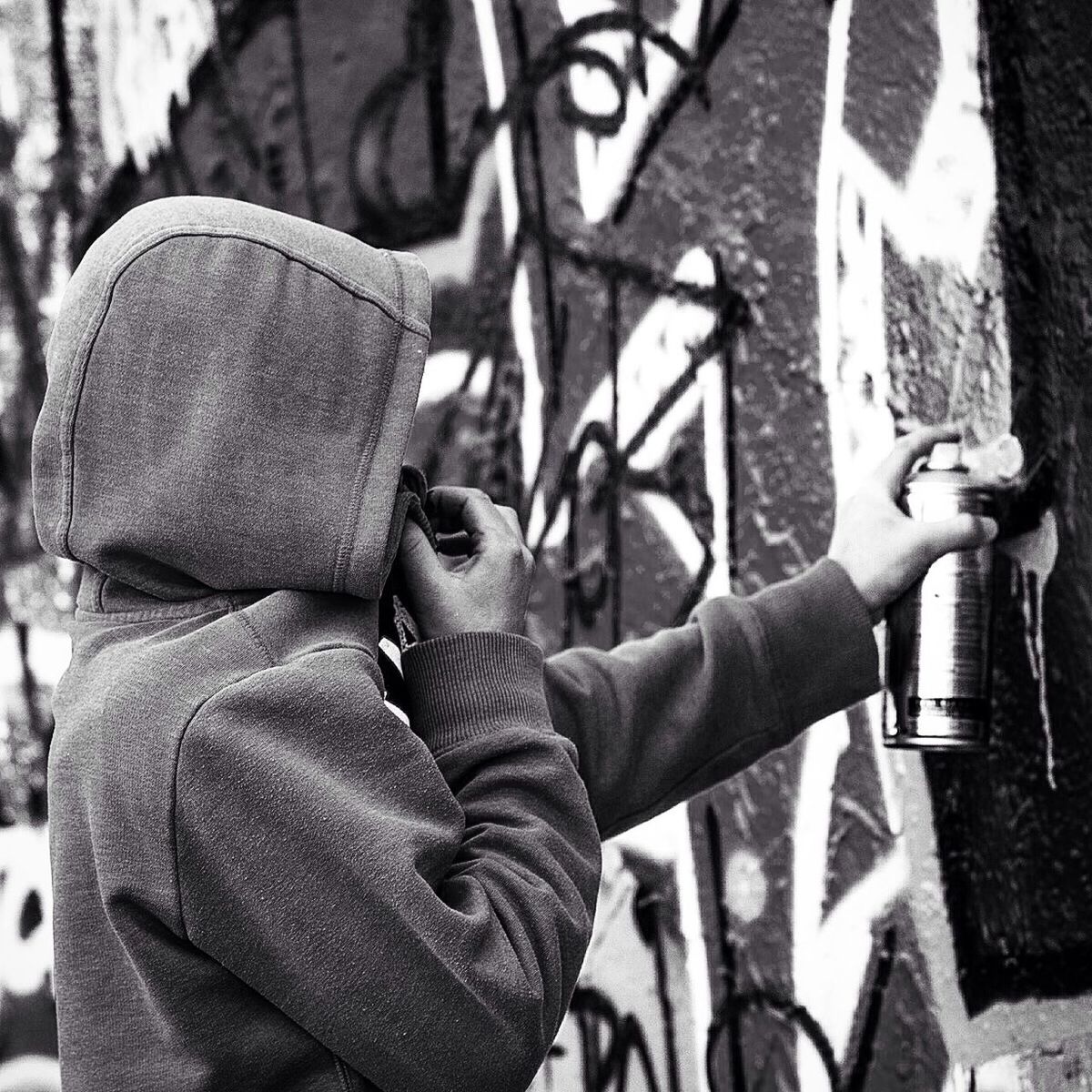 Side view of man doing graffiti