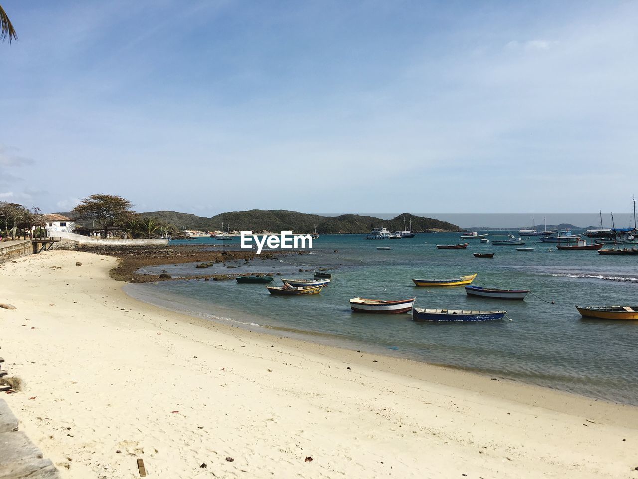 Boats moored on beach against sky