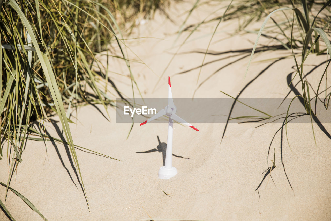 Model wind turbine on the beach in dunes