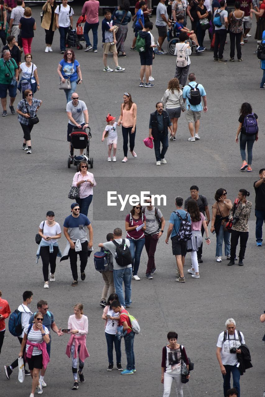 HIGH ANGLE VIEW OF PEOPLE ON STREET