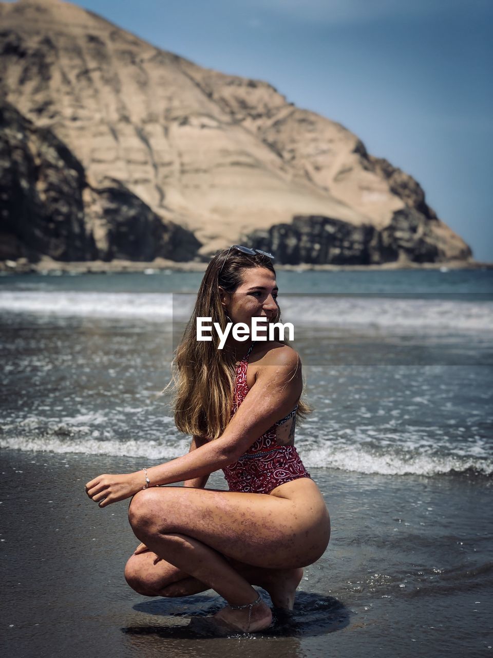 Young woman sitting at beach