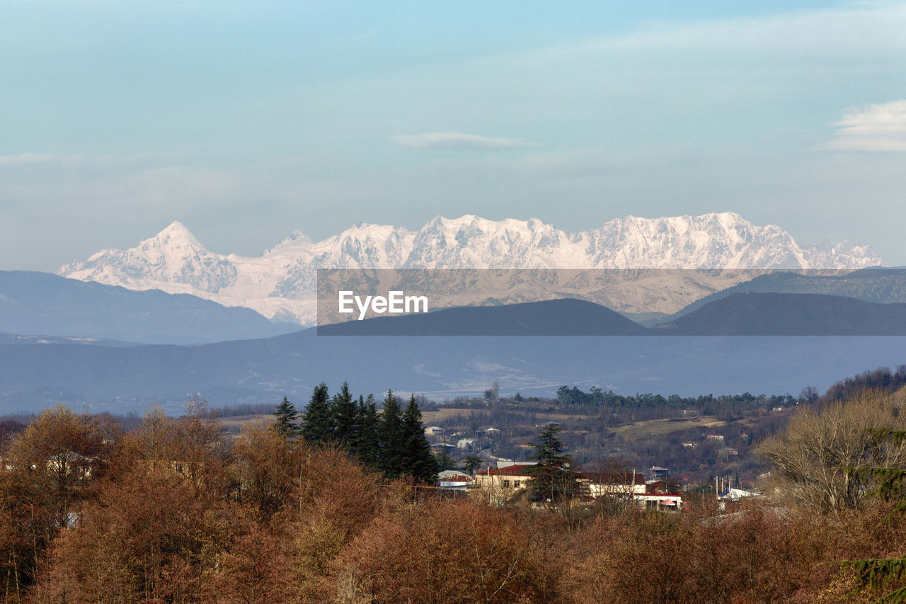 Scenic view of landscape and mountains against sky