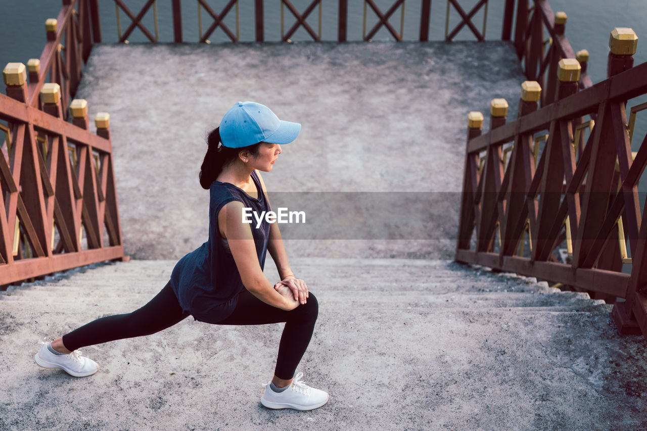 Sportwoman exercise stretching on stairs outdoor healthy lifestyle