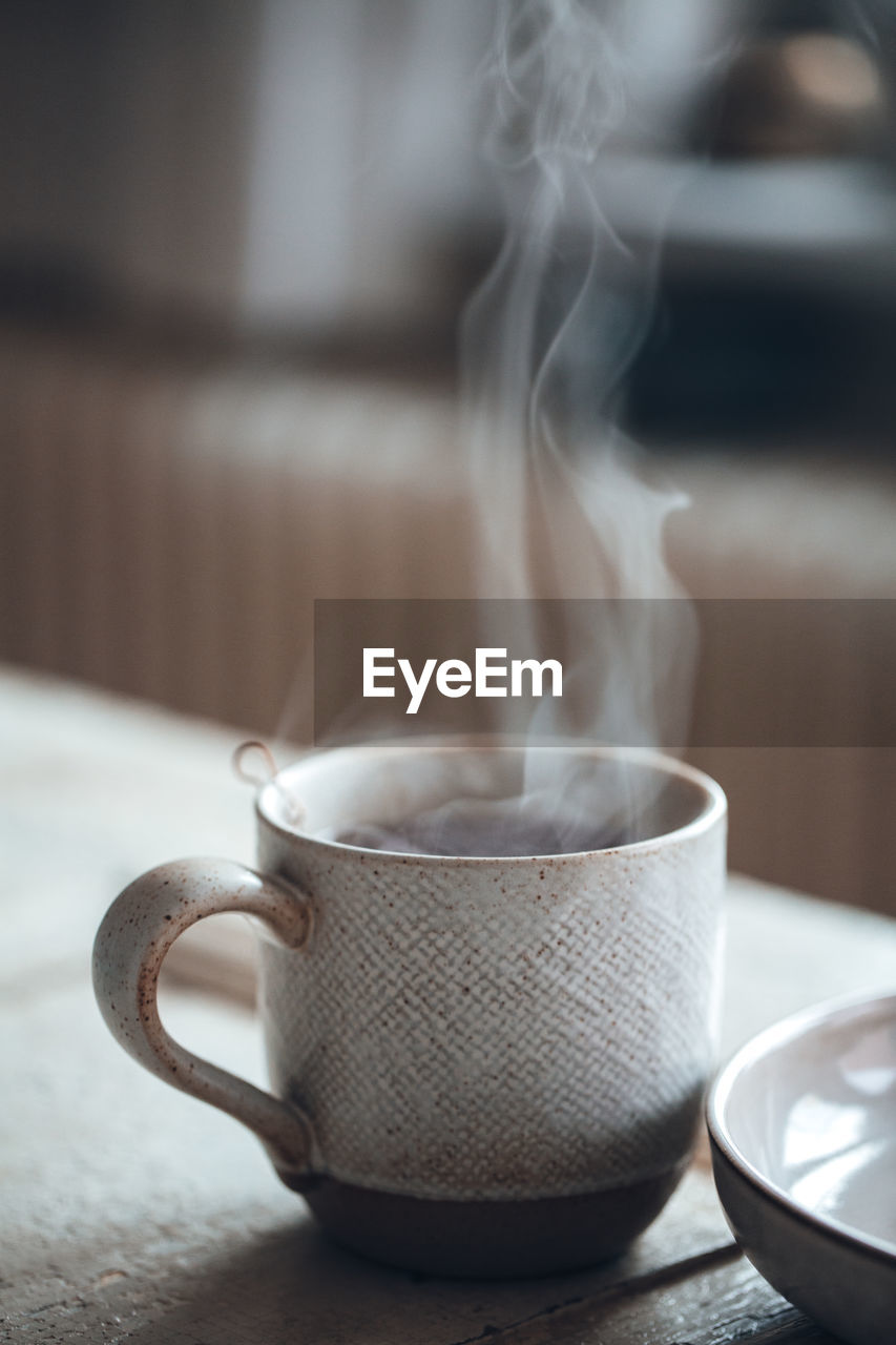 Close-up of steaming hot beverage in cup