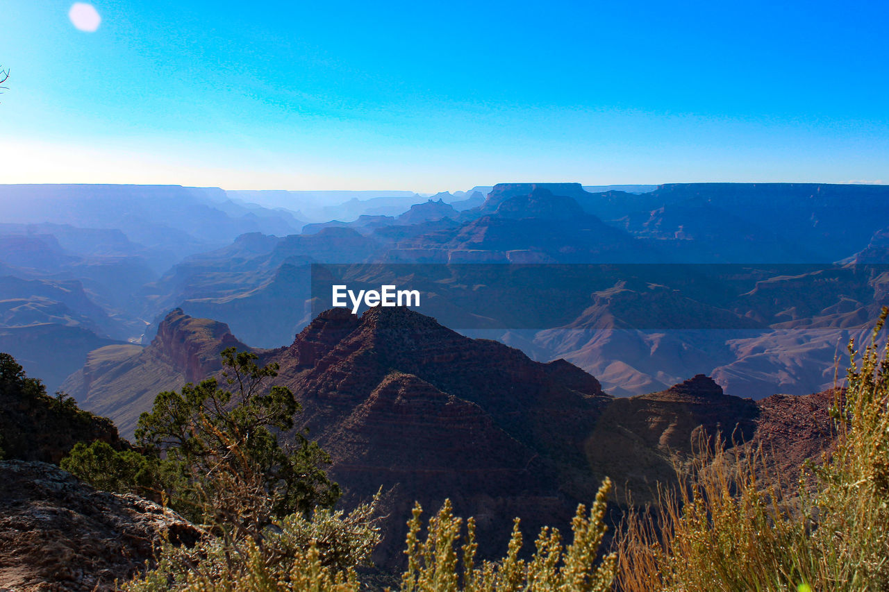 SCENIC VIEW OF MOUNTAIN AGAINST BLUE SKY