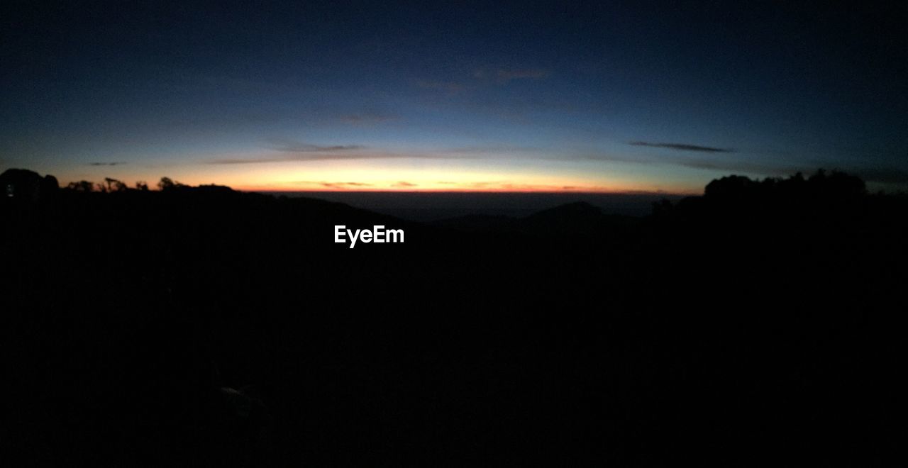 SCENIC VIEW OF SILHOUETTE LANDSCAPE AGAINST SKY DURING SUNSET