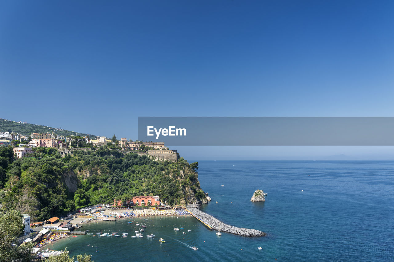 High angle view of sea against clear blue sky