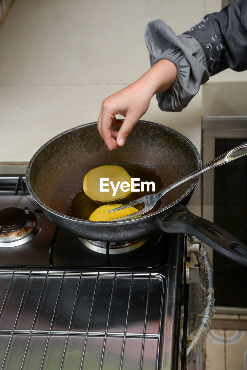 Cropped hand of person preparing food