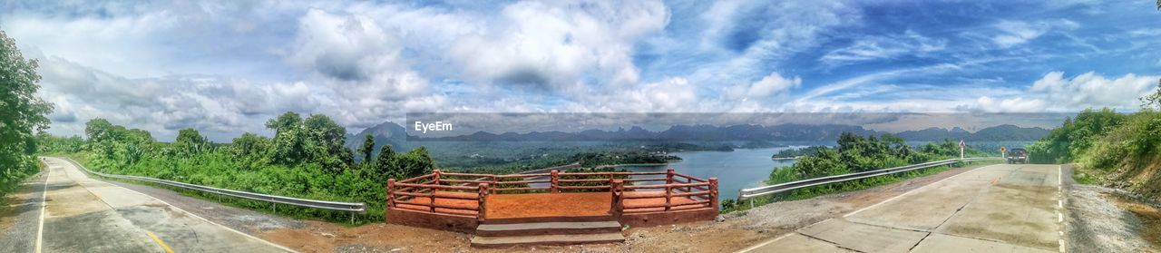 PANORAMIC VIEW OF TREES AND MOUNTAINS AGAINST SKY