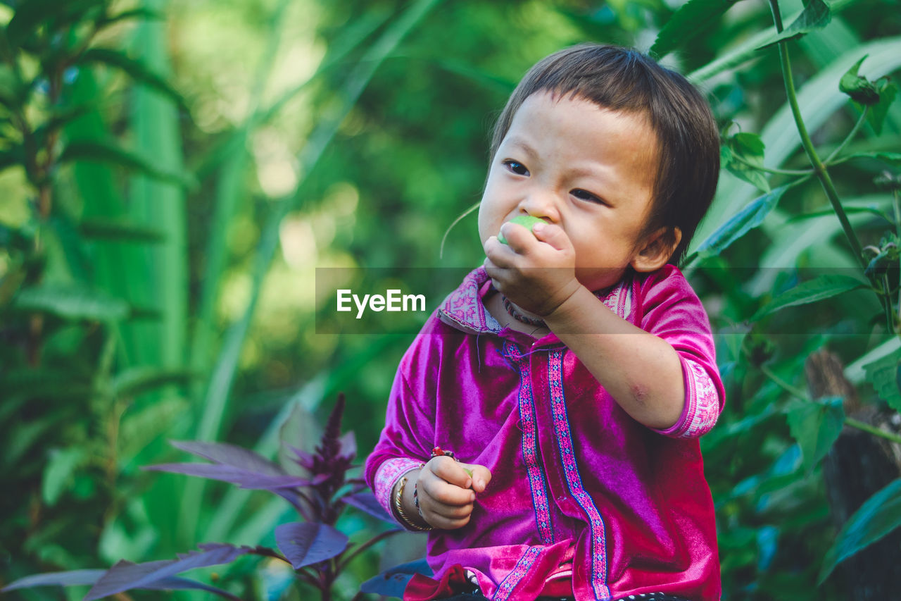 PORTRAIT OF CUTE BABY GIRL STANDING OUTDOORS