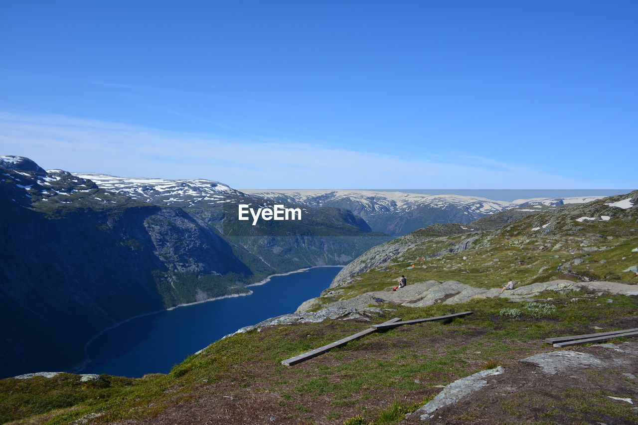 Scenic view of mountains against clear blue sky