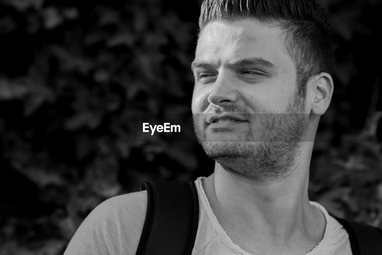 Close-up of young man looking away outdoors