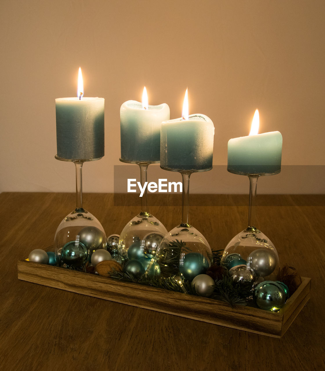 Close-up of candles on glasses over table