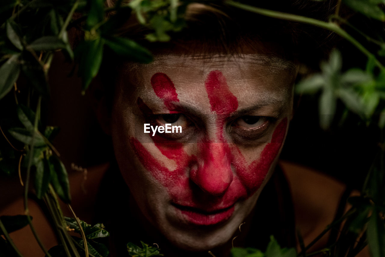 CLOSE-UP PORTRAIT OF WOMAN WITH RED FACE