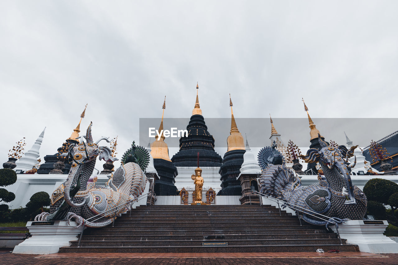 Low angle view of temple against cloudy sky