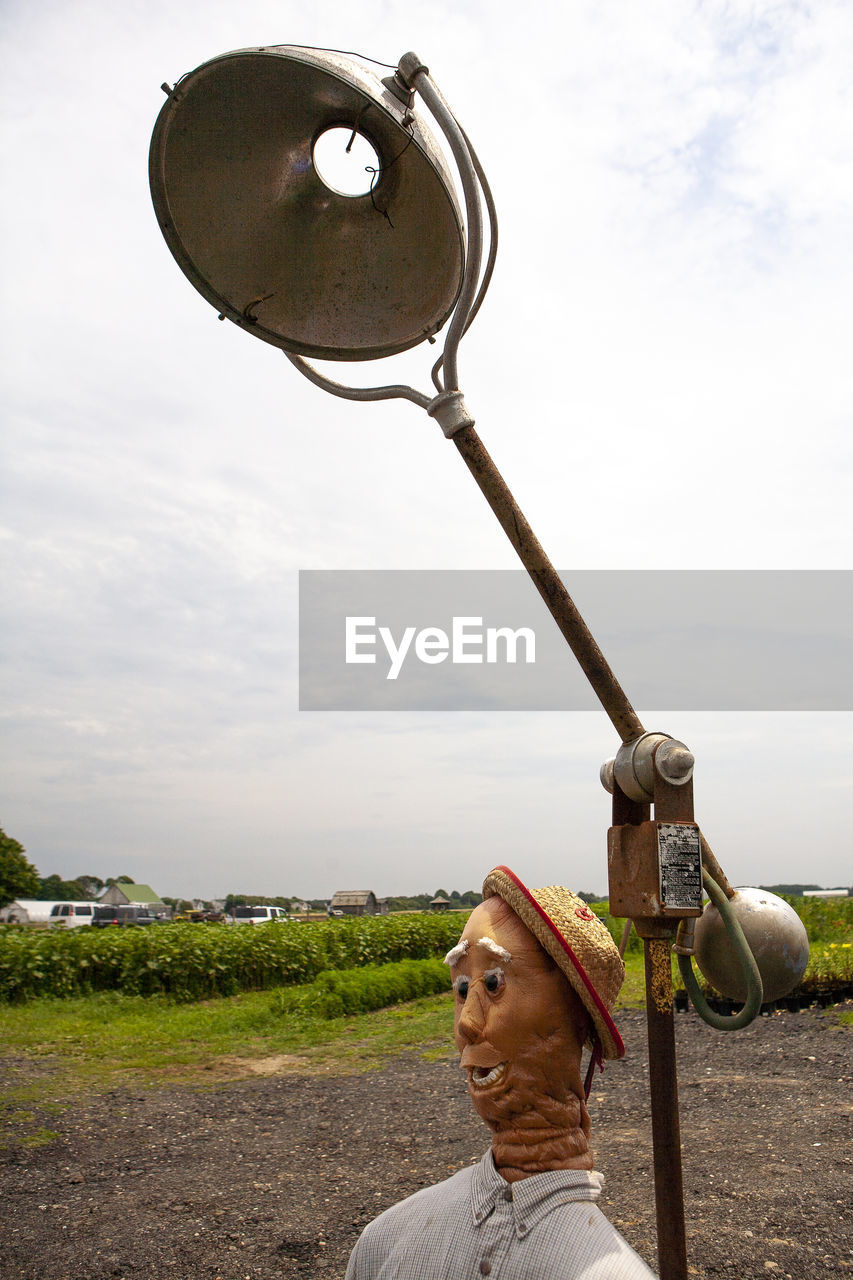 PORTRAIT OF MAN STANDING AGAINST SKY