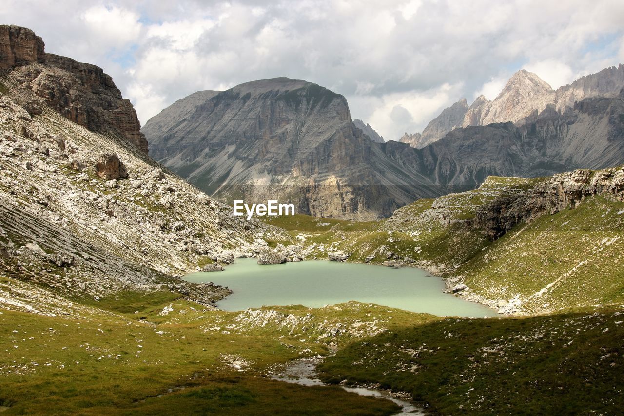 Scenic view of lake and mountains against sky