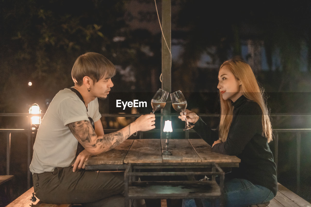 COUPLE SITTING ON TABLE AT CAFE