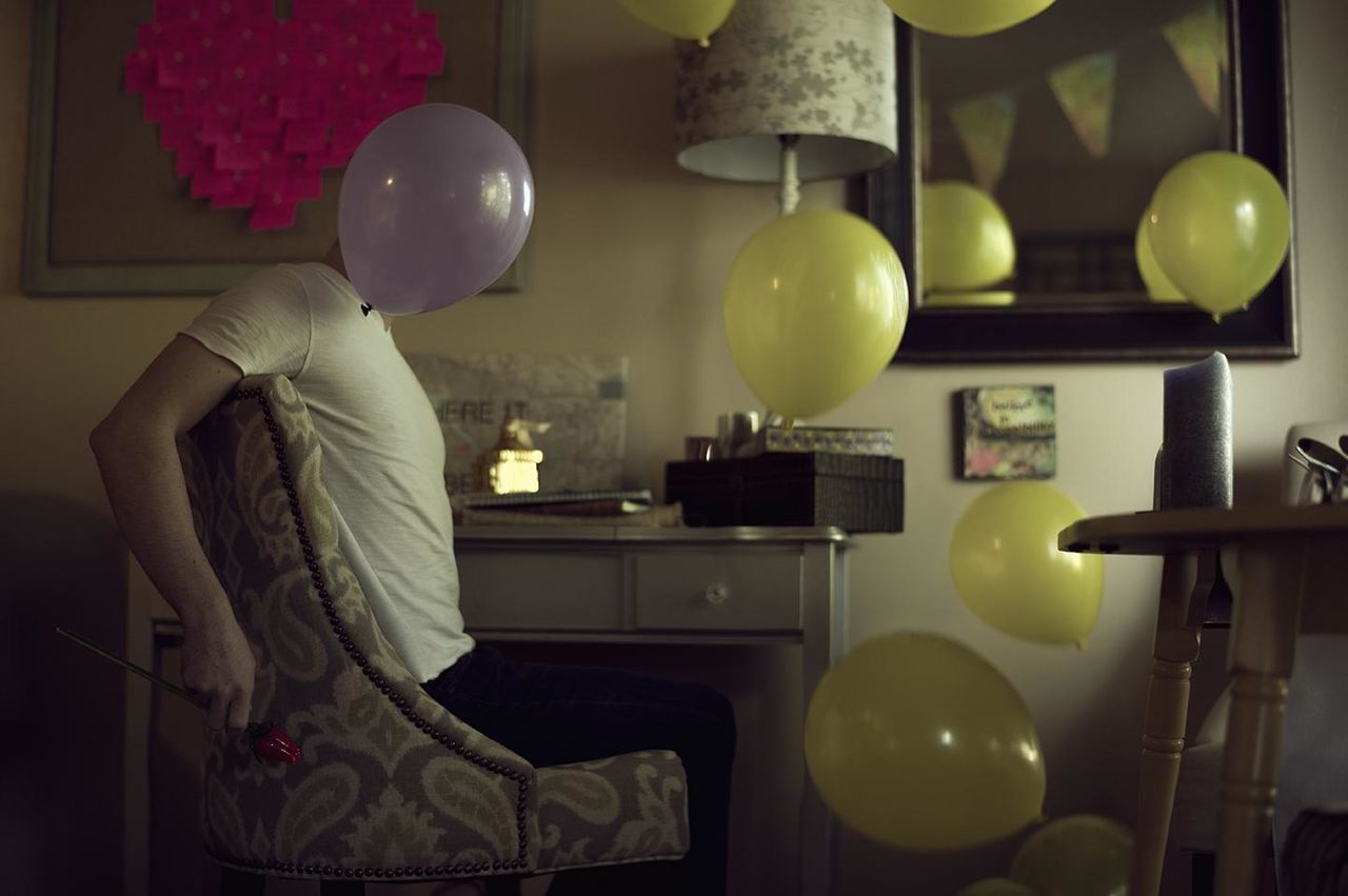 Man in room with balloons