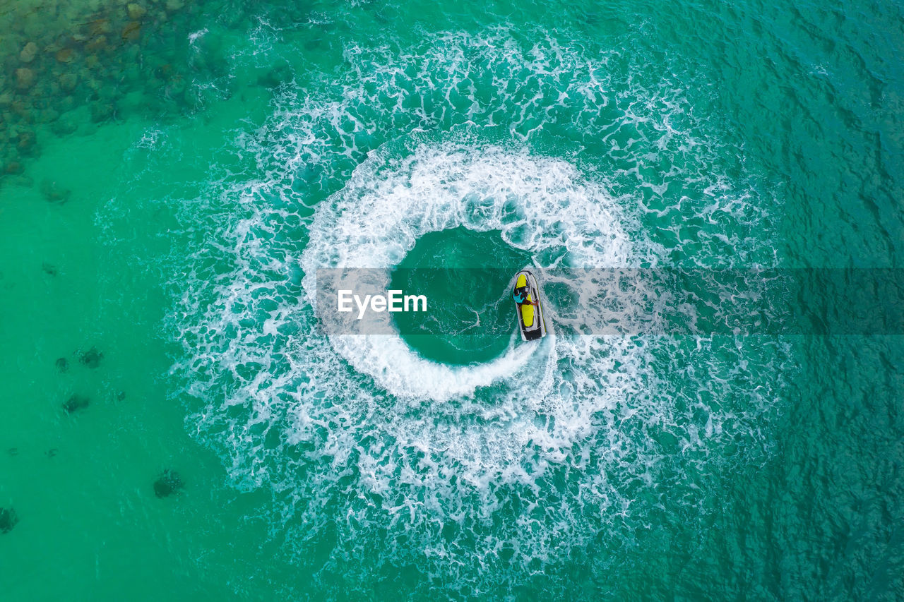 People are playing a jet ski in the sea.aerial view.