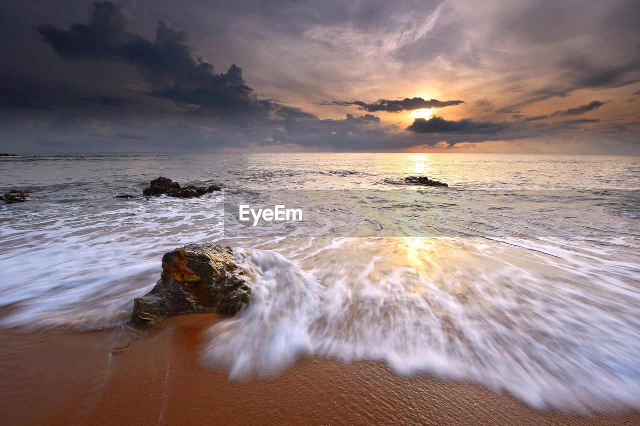 Scenic view of sea against sky during sunset