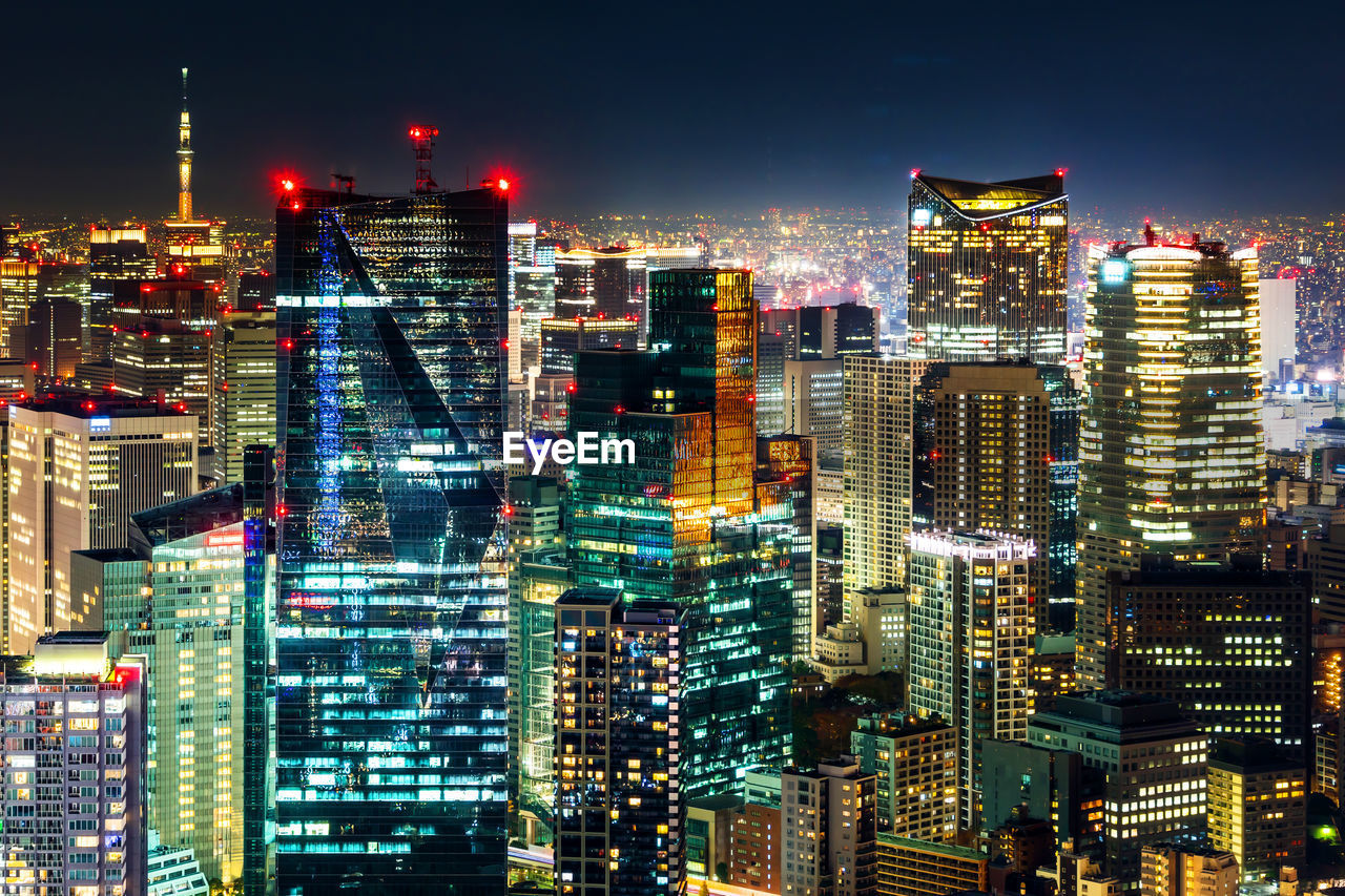 ILLUMINATED BUILDINGS AGAINST SKY AT NIGHT