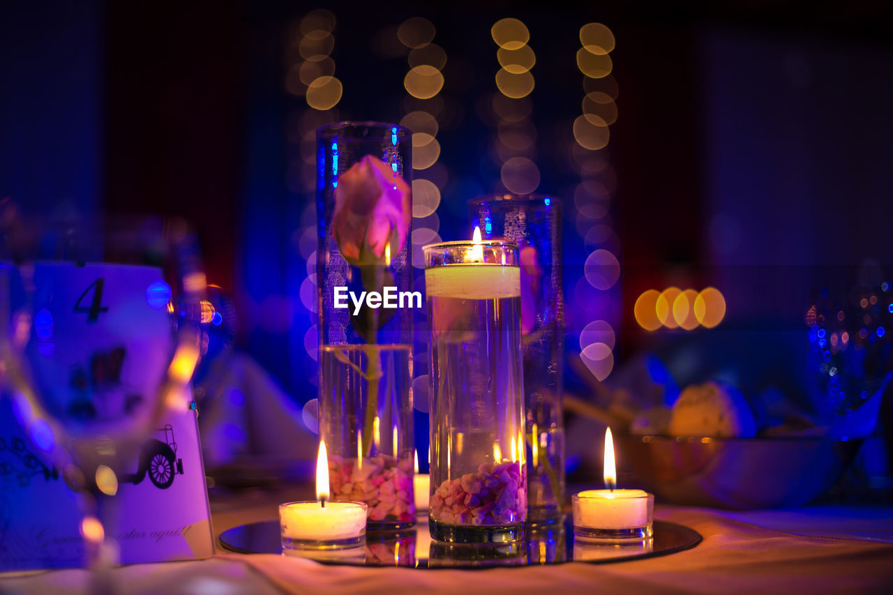 Illuminated candles on table in restaurant