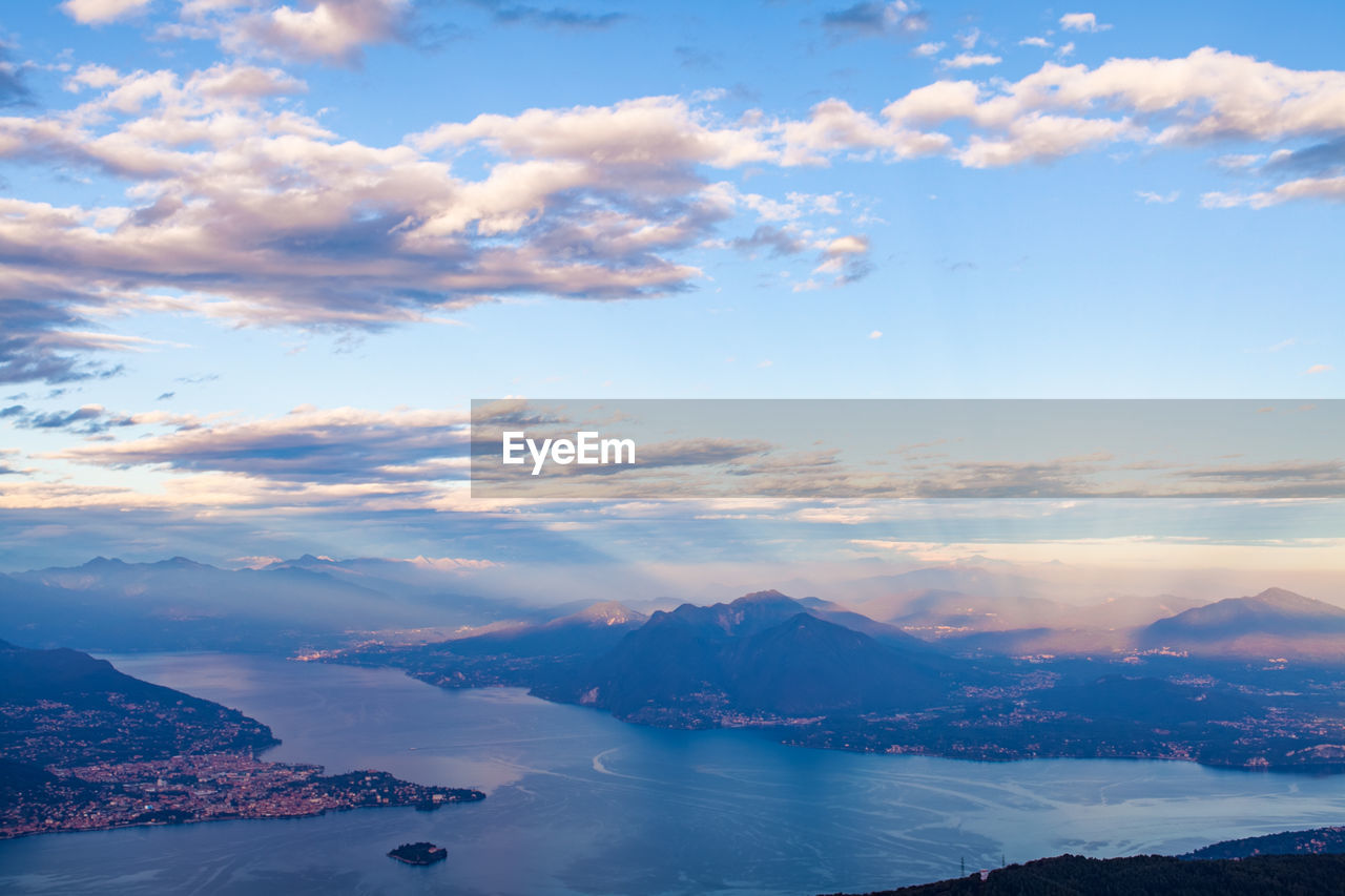 Scenic view of sea and snowcapped mountains against sky during sunset