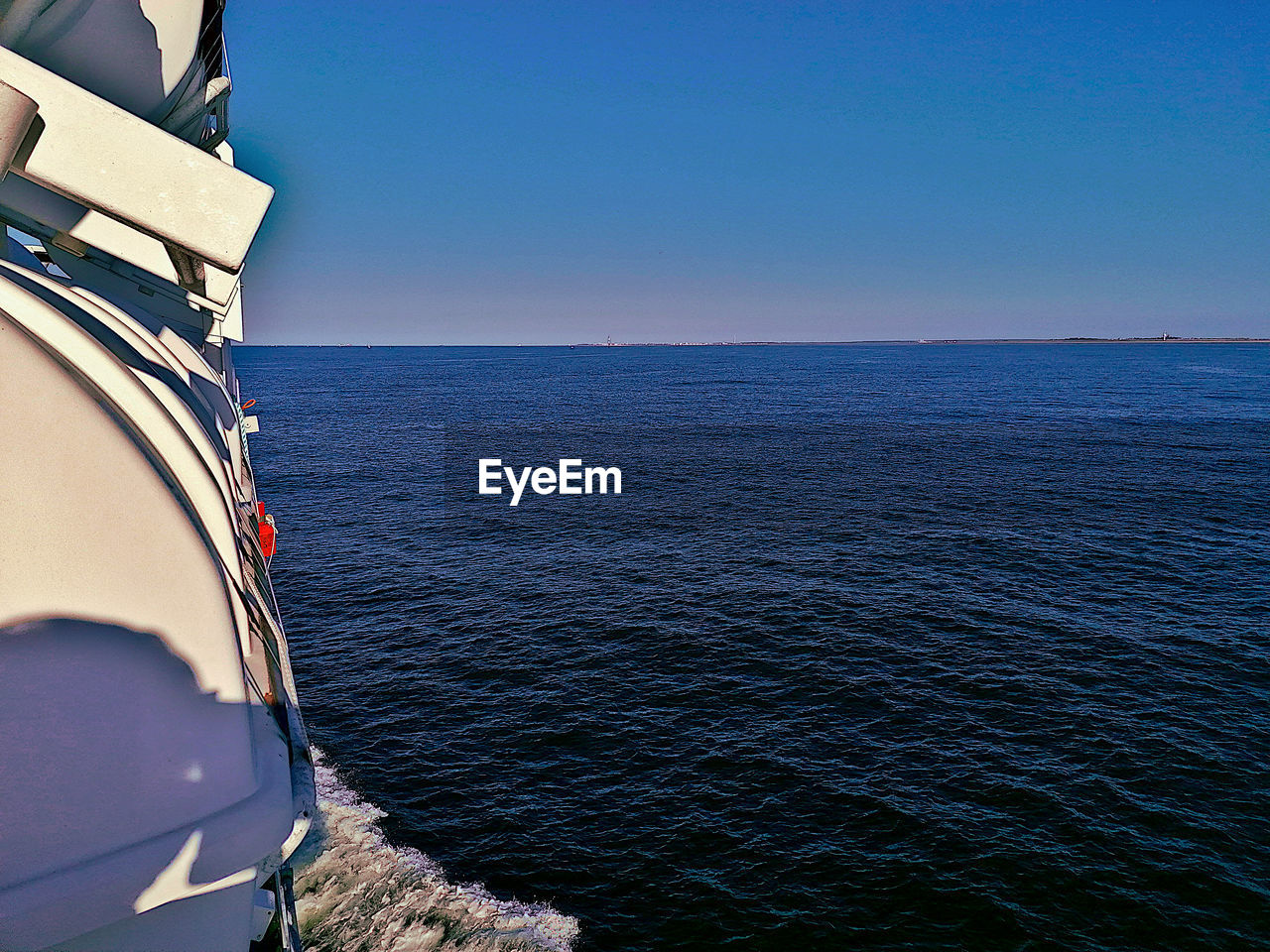 SAILBOAT IN SEA AGAINST CLEAR SKY