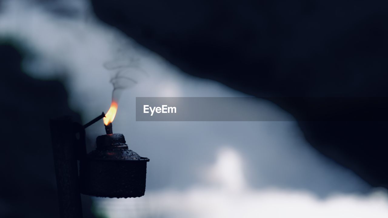 Close-up of hand holding burning pelita raya