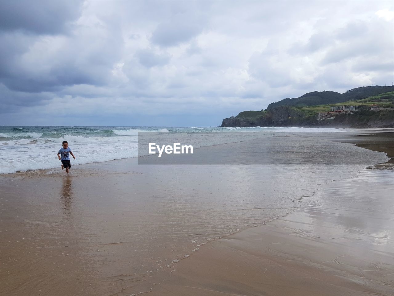 Scenic view of sea against sky. boy on the beach